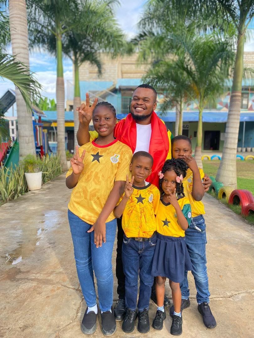 Young Nursery children at Regina Mundi outdoors with a staff member