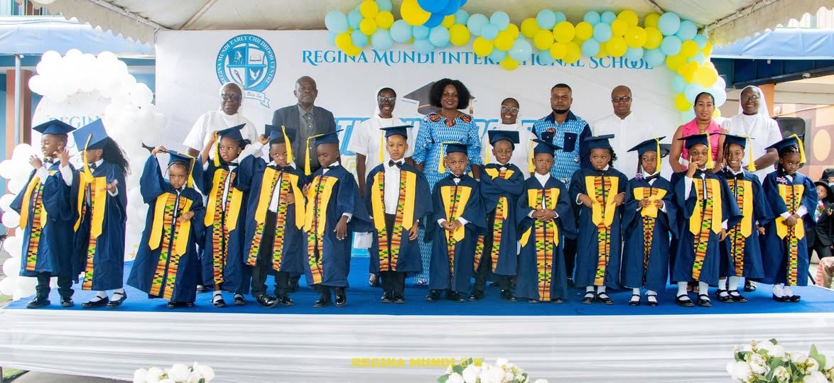 Regina Mundi KG pupils in graduation gowns and kente sashes on stage