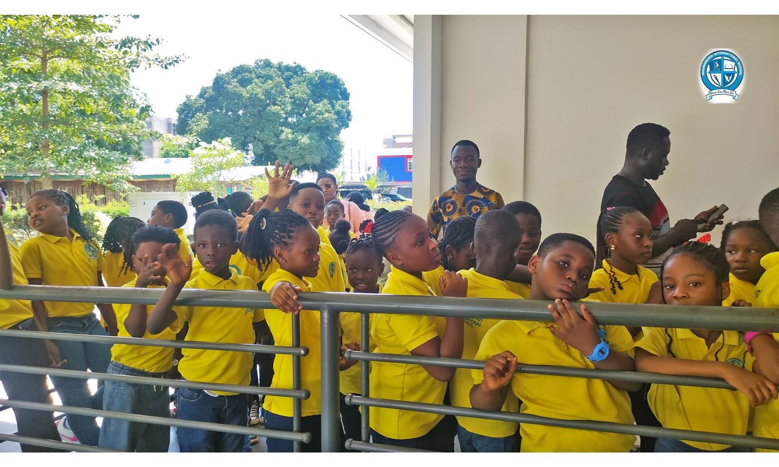 Regina Mundi pupils waving and smiling at the school balcony railing